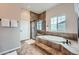 Main bathroom with soaking tub and walk-in shower at 7892 S Country Club Pkwy, Aurora, CO 80016