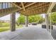 Concrete patio with seating area and tree backdrop at 7892 S Country Club Pkwy, Aurora, CO 80016