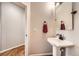 Small powder room with pedestal sink and a mirror at 7892 S Country Club Pkwy, Aurora, CO 80016