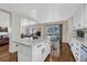 Spacious kitchen featuring granite countertops and modern white cabinetry at 10073 Blackbird Pl, Littleton, CO 80130