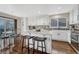 Modern kitchen with white cabinets, granite countertops, and stainless steel appliances at 10073 Blackbird Pl, Littleton, CO 80130