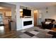 Living room featuring a fireplace, hardwood floors, and an open floor plan at 268 Belford Dr, Northglenn, CO 80260