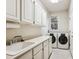 Convenient laundry room with washer, dryer, and cabinets at 4756 E Pinewood Cir, Centennial, CO 80121