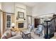 Bright living room with hardwood floors, fireplace, and view to dining room at 4756 E Pinewood Cir, Centennial, CO 80121