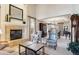 Living room with fireplace and view into the formal dining area at 4756 E Pinewood Cir, Centennial, CO 80121