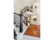 Elegant curved staircase with dark wood railing and hardwood floors at 4756 E Pinewood Cir, Centennial, CO 80121