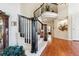 Elegant curved staircase with dark wood railing and hardwood floors at 4756 E Pinewood Cir, Centennial, CO 80121