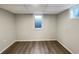 Finished basement room with vinyl flooring and a window at 1059 S Saulsbury St, Lakewood, CO 80226