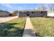 Charming ranch home with a landscaped lawn and walkway at 1059 S Saulsbury St, Lakewood, CO 80226