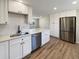 Modern kitchen with white shaker cabinets and stainless steel appliances at 1059 S Saulsbury St, Lakewood, CO 80226