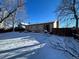 Snow-covered backyard, offering a view of the home's exterior at 15503 E Princeton Ave, Aurora, CO 80013