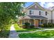Two-story townhome with a front porch and landscaped yard at 22580 E Ontario Dr # 103, Aurora, CO 80016