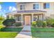 Townhome entrance with a covered porch and landscaping at 22580 E Ontario Dr # 103, Aurora, CO 80016