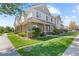 Two-story townhome with green exterior and landscaping at 22580 E Ontario Dr # 103, Aurora, CO 80016