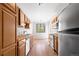 Kitchen with wood cabinets, stainless steel appliances, and tile floor at 22580 E Ontario Dr # 103, Aurora, CO 80016