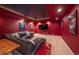 Finished basement home theater with red walls and sectional sofa at 5861 E Valley Hi Dr, Parker, CO 80138