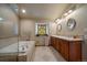 Bathroom with double vanity, soaking tub, and walk-in shower at 5861 E Valley Hi Dr, Parker, CO 80138