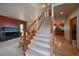 Elegant staircase with wood railings, leading to the upper level at 5861 E Valley Hi Dr, Parker, CO 80138