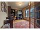 Bright home office with built-in shelving and hardwood floors at 5861 E Valley Hi Dr, Parker, CO 80138