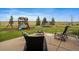 Patio with seating area and fire pit, overlooking yard at 5861 E Valley Hi Dr, Parker, CO 80138