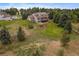 Aerial view of house, expansive backyard, and surrounding land at 5861 E Valley Hi Dr, Parker, CO 80138