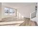 Bright living room with hardwood floors and large windows at 202 Corkscrew St, Elizabeth, CO 80107