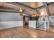 Open-concept living area with wood-beamed ceiling, fireplace, and view of the kitchen at 12440 Ash Dr, Thornton, CO 80241