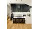 Modern kitchen with white cabinets, a large island, and stylish pendant lights at 2556 18Th St, Denver, CO 80211