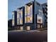 Three modern townhouses at night, showcasing a contemporary design and sleek architecture at 2556 18Th St, Denver, CO 80211