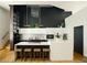 Modern kitchen with white cabinets, a large island, and stylish pendant lights at 2556 18Th St, Denver, CO 80211