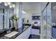 Elegant bathroom with double sinks and a view of the bedroom at 1230 Sugarloaf Ln, Erie, CO 80516