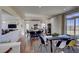Modern kitchen with white cabinets, large island, and a dining area at 1230 Sugarloaf Ln, Erie, CO 80516