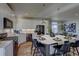 Modern kitchen with white cabinets, large island, and stainless steel appliances at 1230 Sugarloaf Ln, Erie, CO 80516