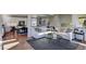 Bright living room with hardwood floors, white sectional sofa and a view of the kitchen at 1230 Sugarloaf Ln, Erie, CO 80516