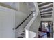Modern staircase with gray carpeting and wooden handrail at 1230 Sugarloaf Ln, Erie, CO 80516