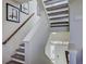 Modern staircase with gray carpeting and wood railing at 1230 Sugarloaf Ln, Erie, CO 80516