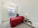 Bright bedroom with a red bedspread and window blinds at 16487 E 111Th Pl, Commerce City, CO 80022