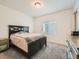 Bedroom with a dark brown bed frame and teal nightstand at 16487 E 111Th Pl, Commerce City, CO 80022