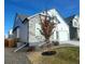 Two-story home with stone and white siding, landscaped yard, and a two-car garage at 16487 E 111Th Pl, Commerce City, CO 80022