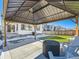 Cozy backyard patio with pergola, fire pit, and artificial turf at 16487 E 111Th Pl, Commerce City, CO 80022