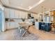 Modern kitchen with white cabinets, a large island, and stainless steel appliances at 16487 E 111Th Pl, Commerce City, CO 80022