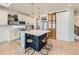 Stylish kitchen boasting white cabinetry, a navy blue island, and gold pendant lights at 16487 E 111Th Pl, Commerce City, CO 80022