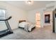 Basement bedroom with treadmill and private bathroom at 16487 E 111Th Pl, Commerce City, CO 80022