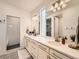 Modern bathroom with double vanity, subway tile shower, and patterned floor at 16487 E 111Th Pl, Commerce City, CO 80022