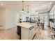 Open concept kitchen with island and views into living and dining areas at 16487 E 111Th Pl, Commerce City, CO 80022