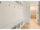 White mudroom with built-in shelves, hooks, and bench at 2681 E 102Nd Pl, Denver, CO 80229