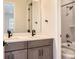 Double vanity bathroom with grey cabinets and quartz countertop at 6664 Bridle Creek Pt, Castle Pines, CO 80108