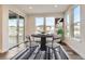 Bright dining area with sliding glass doors and a modern dining set at 6664 Bridle Creek Pt, Castle Pines, CO 80108