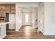 Light and airy entryway with hardwood floors and access to stairs at 6666 Bridle Creek Pt, Castle Pines, CO 80108