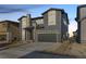 Two-story home with gray siding, stone accents, and a two-car garage at 6664 Bridle Creek Pt, Castle Pines, CO 80108